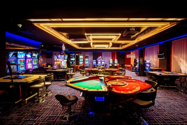 A player using their smartphone during a festive local event, representing JILIDD’s fully mobile-friendly casino.